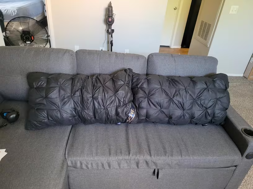 Customer photo of dark Bedhacker pillows on a sofa
